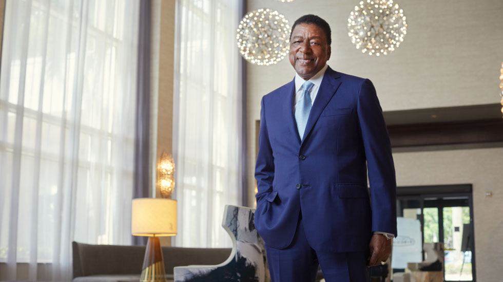 Robert L Johnson stands in a hotel lobby
