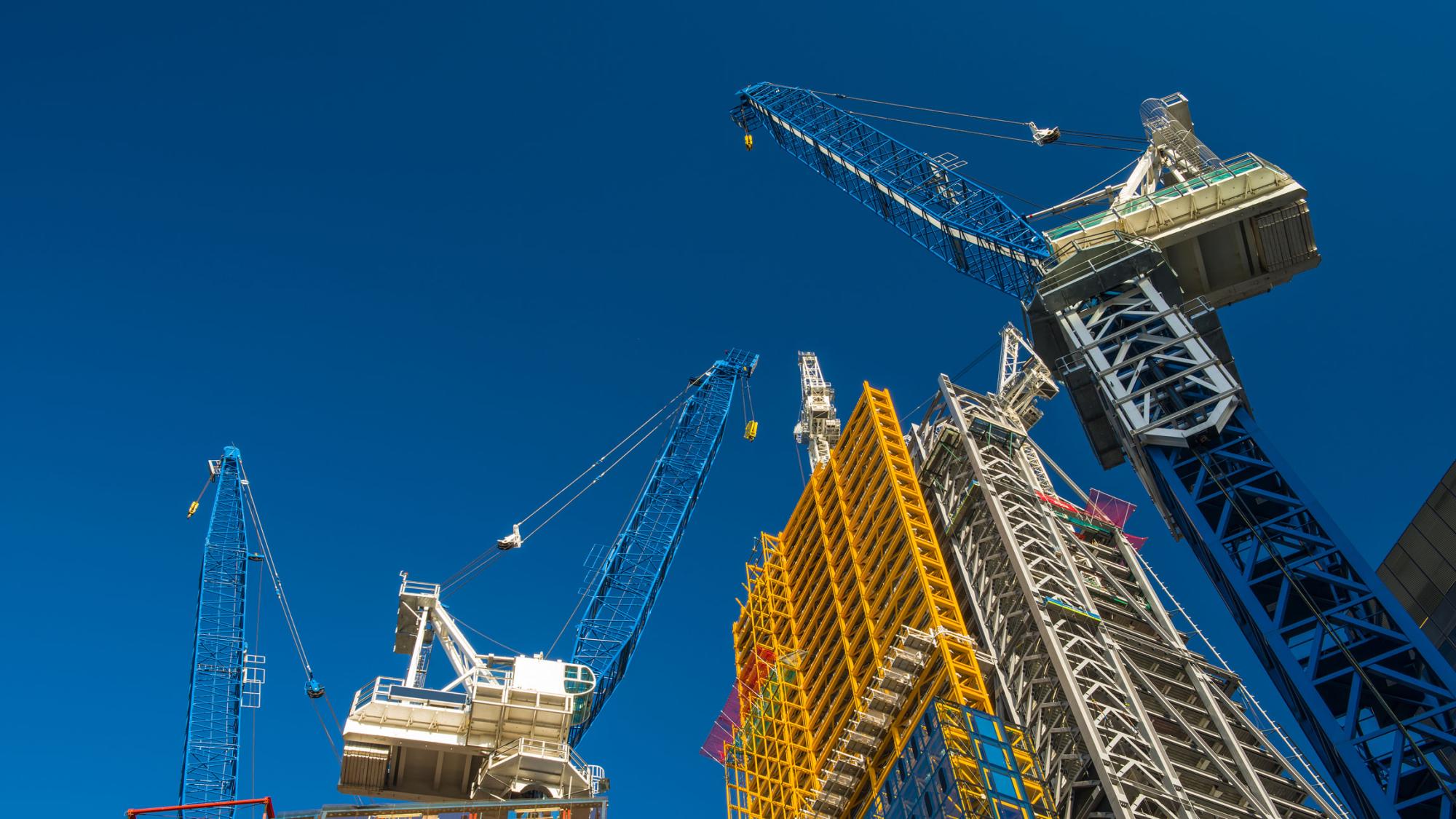 Construction cranes in the sky