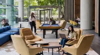 People play pool in an office lobby