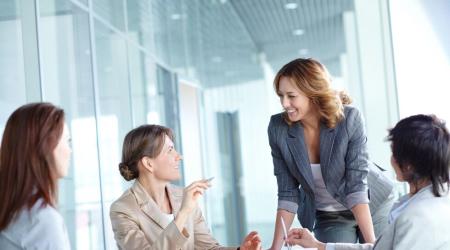 Image of four businesswomen interacting at meeting