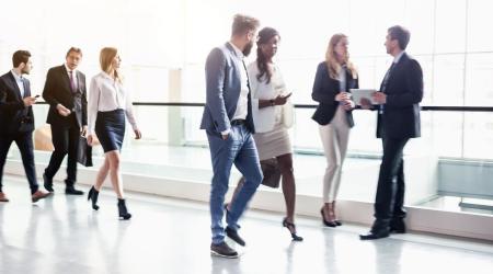 Office workers walking in a well lit hall